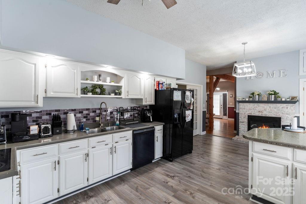 203 Providence Church Road Forest City, NC 28043 - Photo 7 of 46 a kitchen with granite countertop a refrigerator a stove a sink dishwasher and cabinets with wooden floor