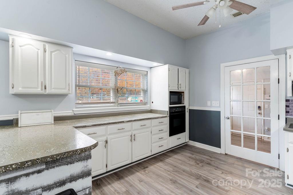 203 Providence Church Road Forest City, NC 28043 - Photo 10 of 46 a kitchen with stainless steel appliances granite countertop a stove a sink and a refrigerator with wooden cabinets