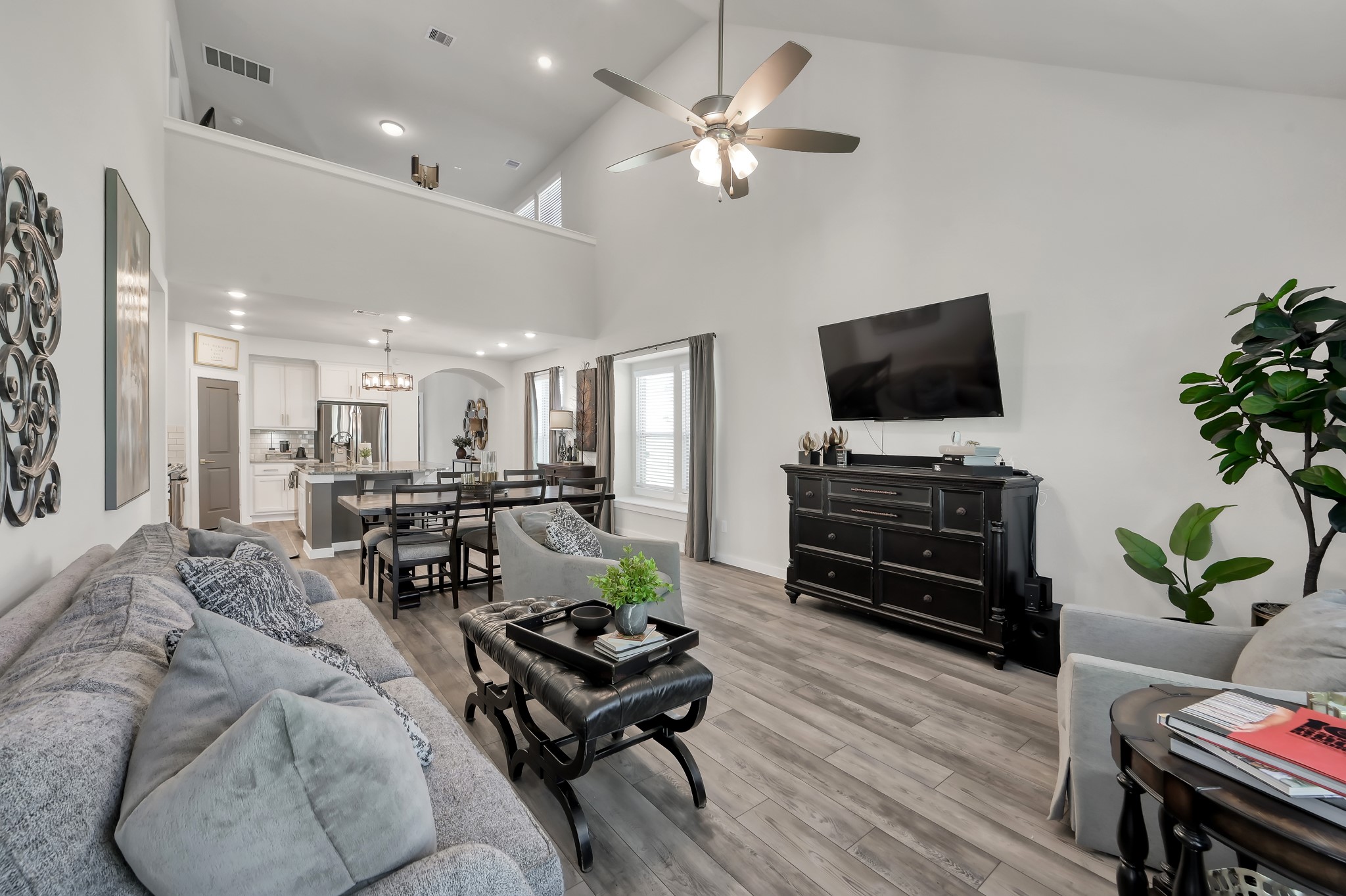 554 Timber Voyage Court Conroe, TX 77304 - Photo 12 of 35 a living room with furniture and a flat screen tv with wooden floor