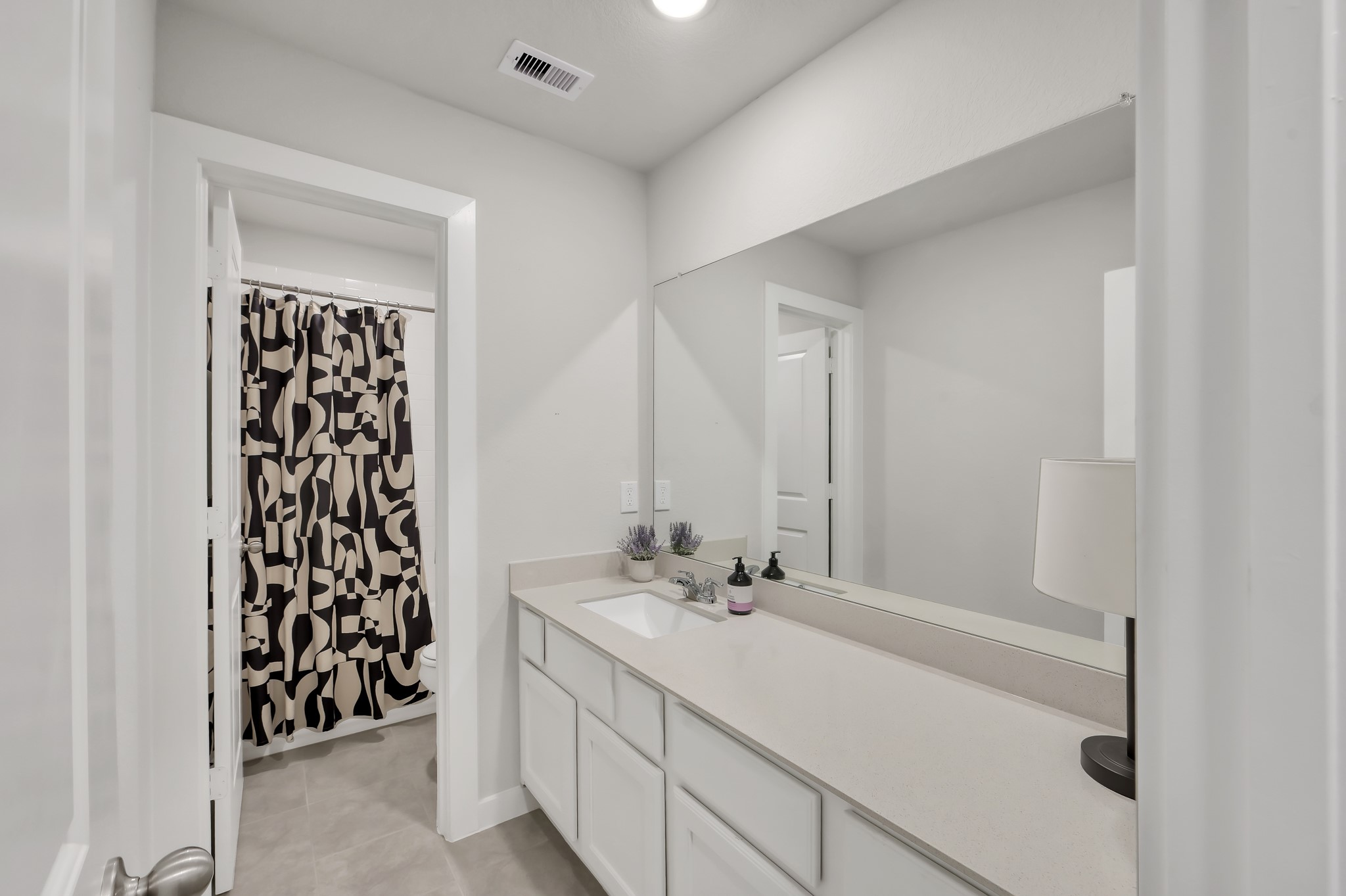 554 Timber Voyage Court Conroe, TX 77304 - Photo 23 of 35 a bathroom with a bathtub sink and mirror