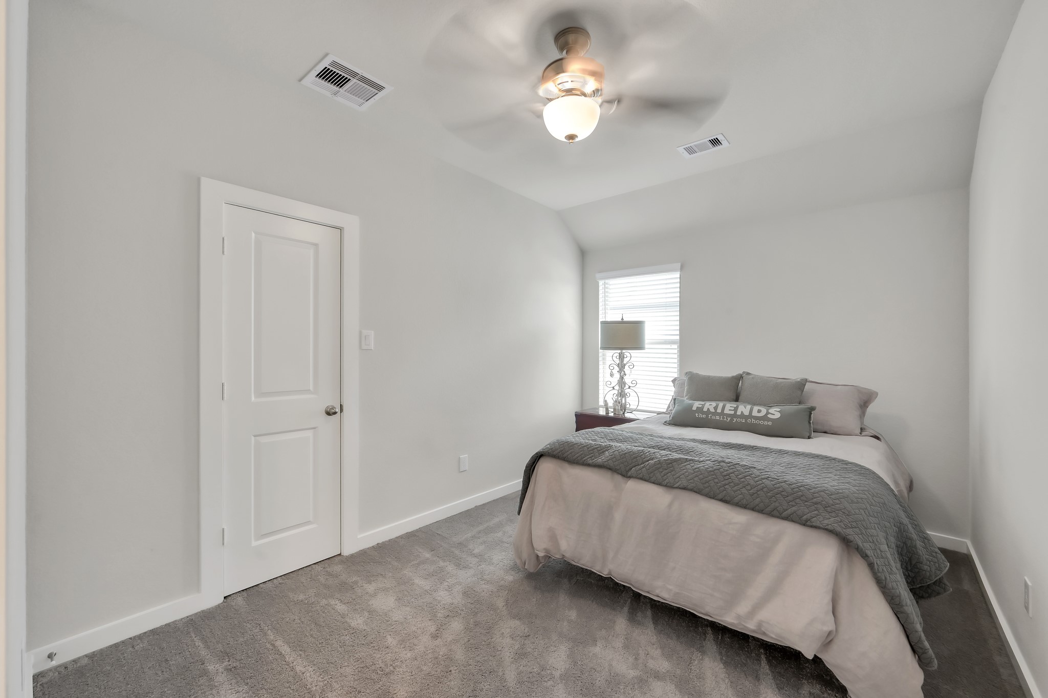 554 Timber Voyage Court Conroe, TX 77304 - Photo 24 of 35 a bedroom with a bed and a chandelier
