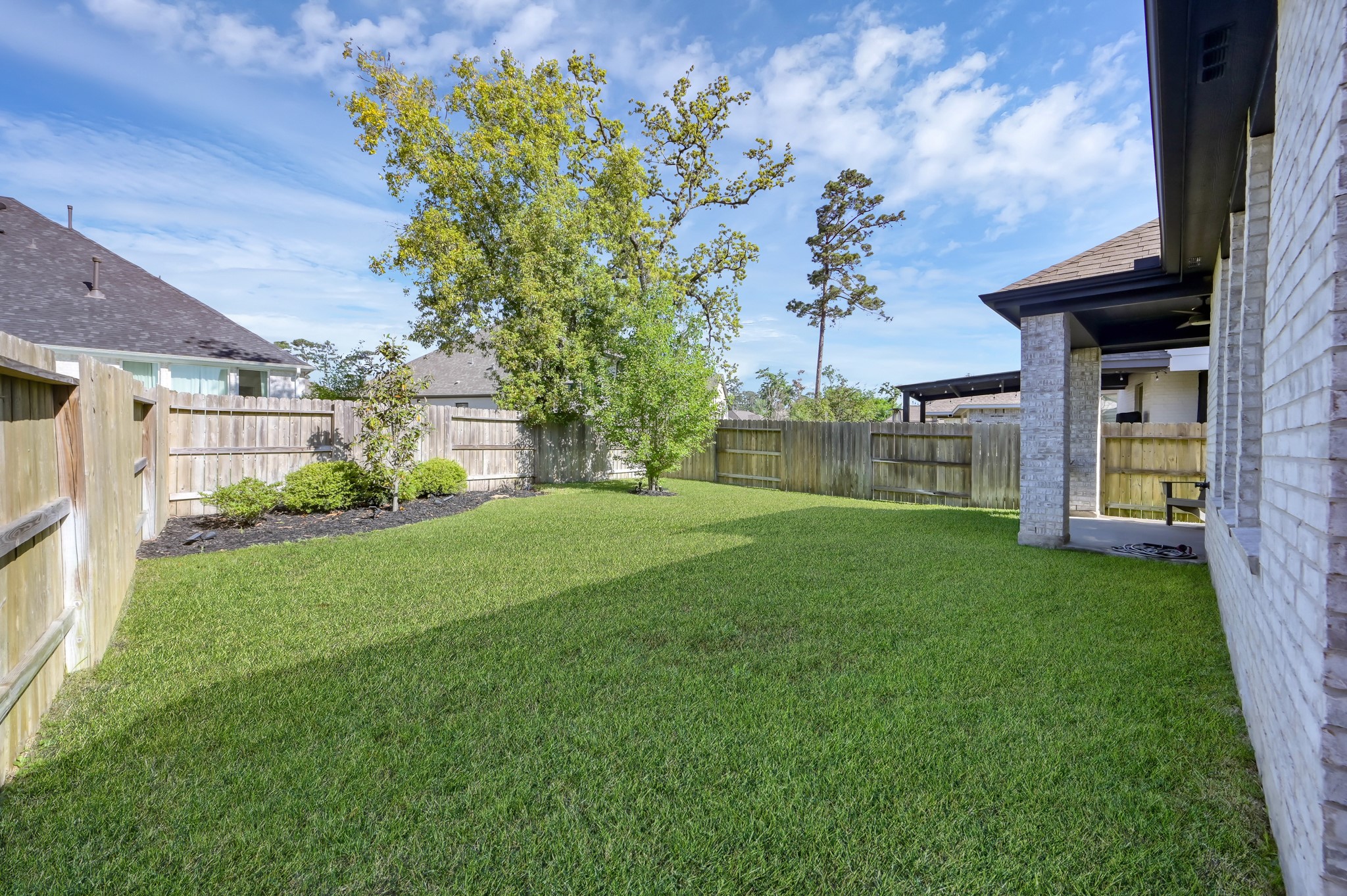 554 Timber Voyage Court Conroe, TX 77304 - Photo 27 of 35 a view of a house with a garden