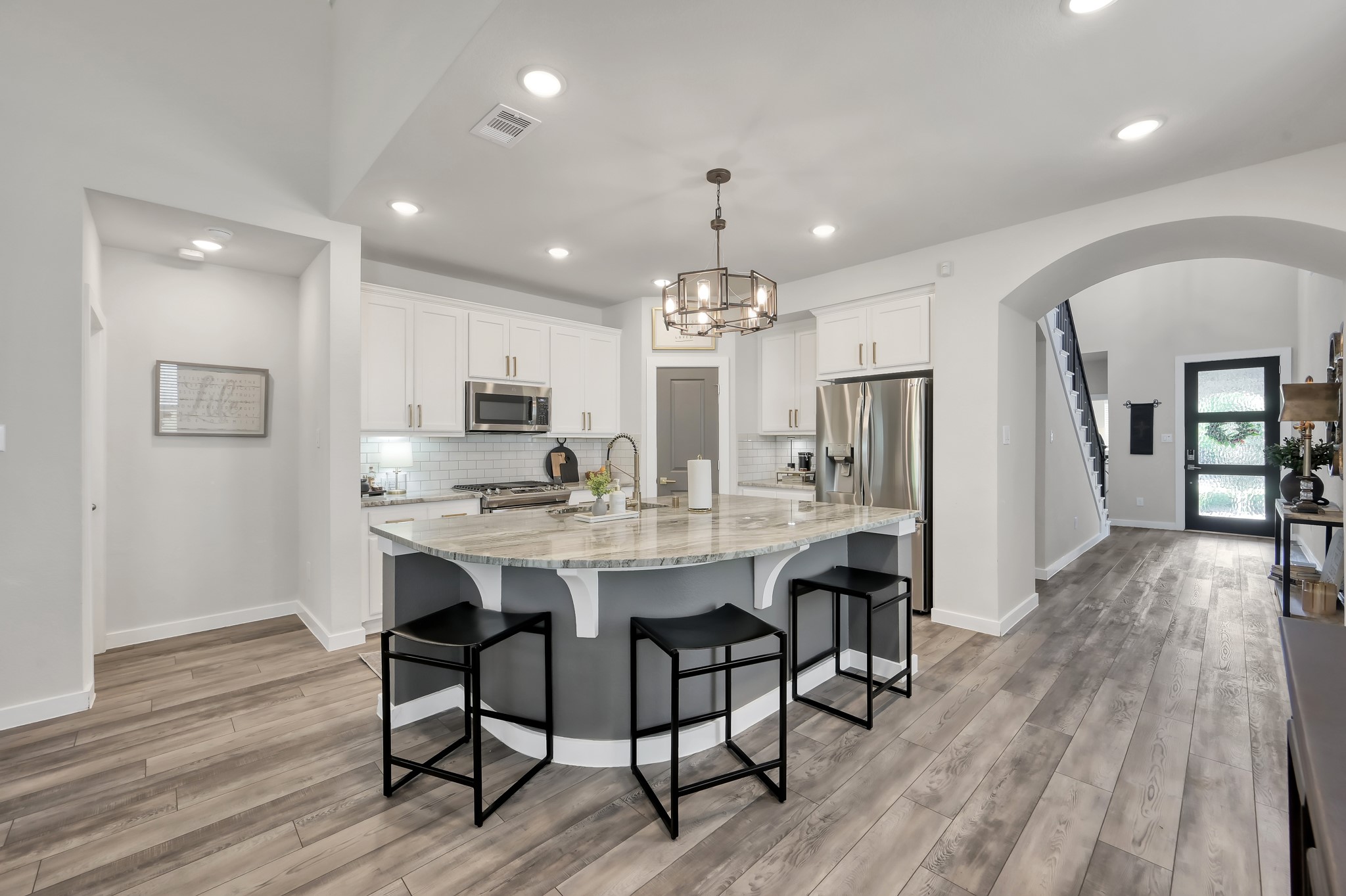 554 Timber Voyage Court Conroe, TX 77304 - Photo 6 of 35 a view of a dining room with furniture wooden floor and chandelier