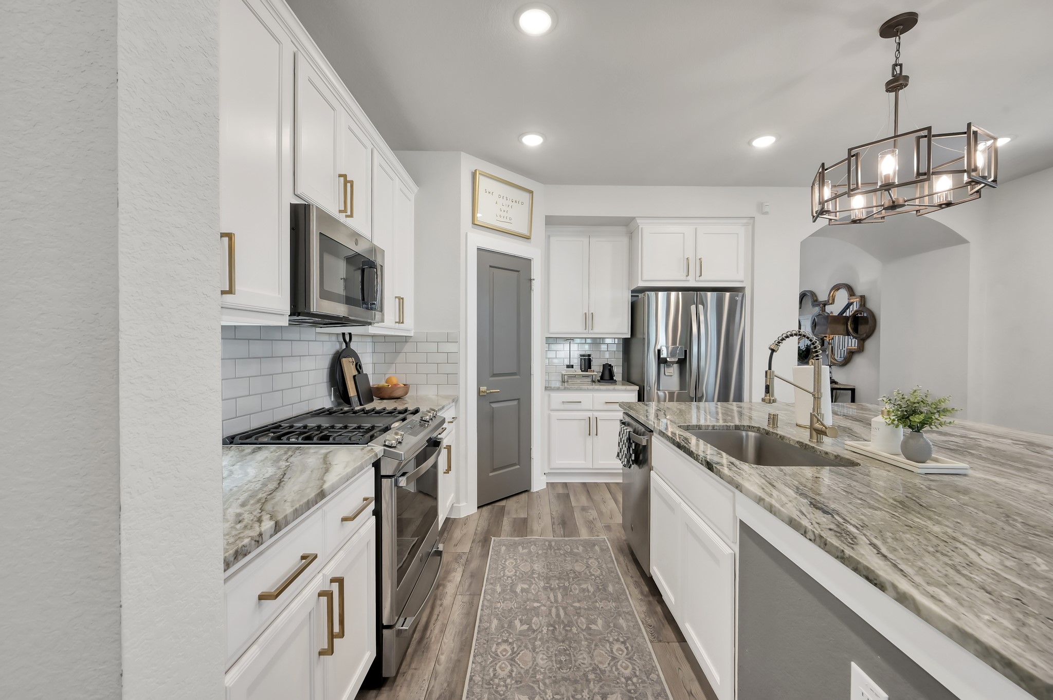 554 Timber Voyage Court Conroe, TX 77304 - Photo 7 of 35 a kitchen with stainless steel appliances granite countertop a sink stove and refrigerator