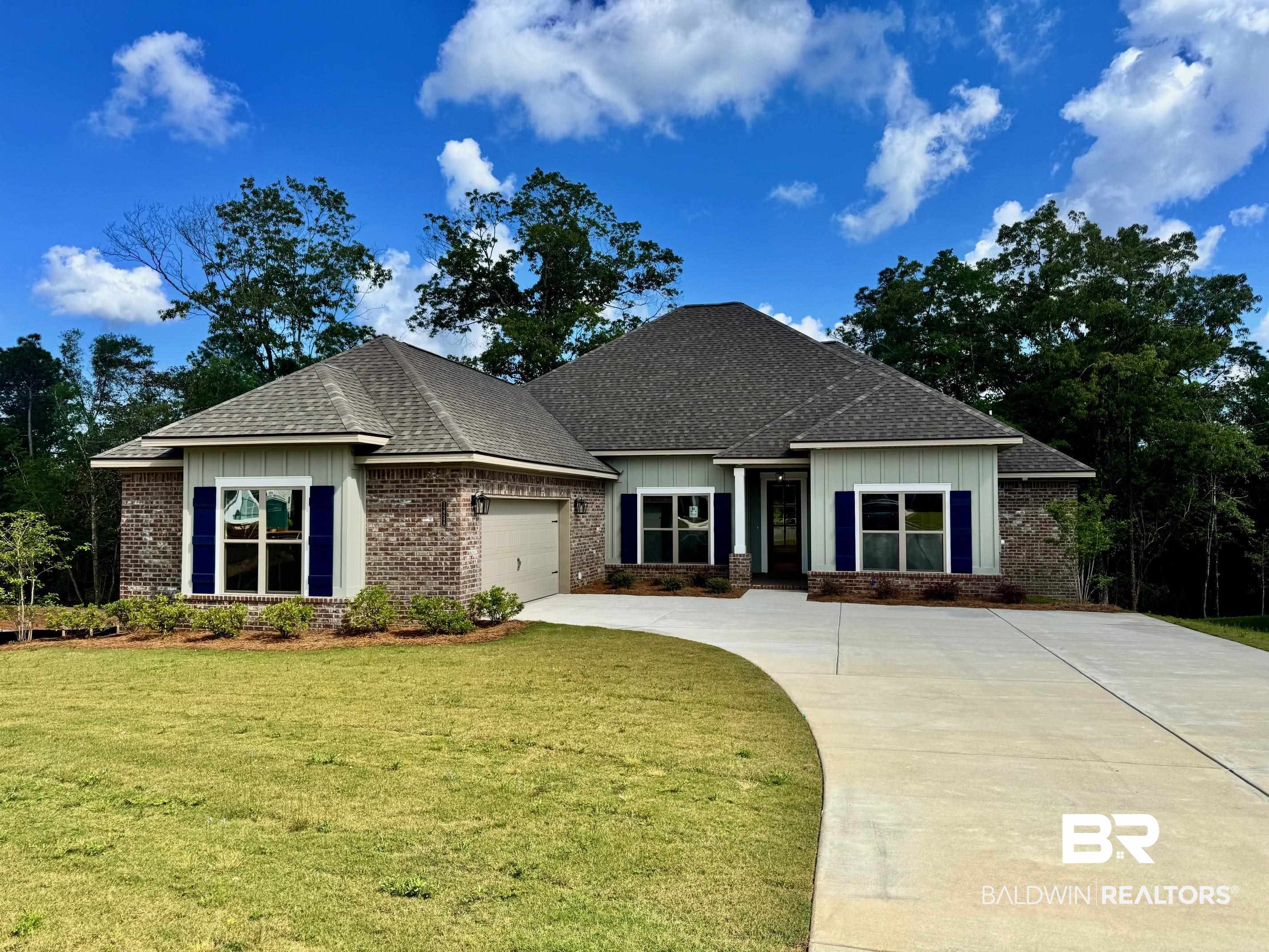 12248 Exbury Way Daphne, AL 36527 - Photo 1 of 63 Craftsman house featuring a shingled roof, an attached garage, concrete driveway, a front lawn, and brick siding