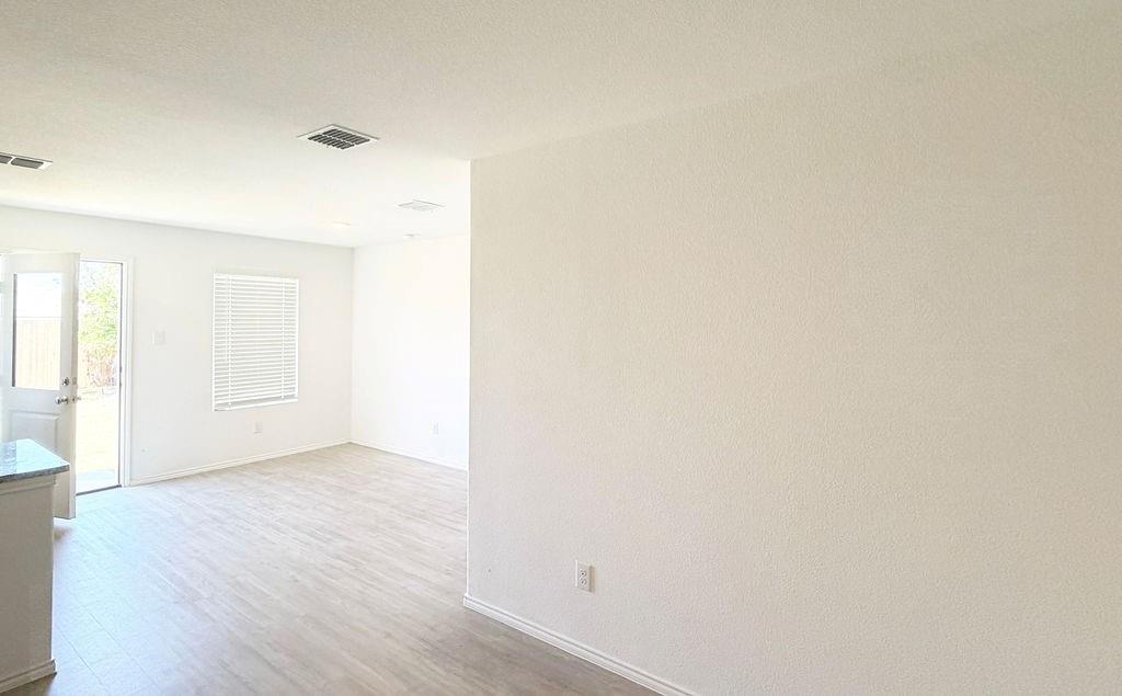7855 Rutherford Lane McKinney, TX 75071 - Photo 21 of 27 Light wood-finish flooring, white walls, recessed lighting, white window blinds, and white door