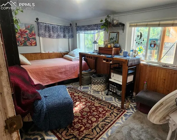 a bed room with a bed and a chair