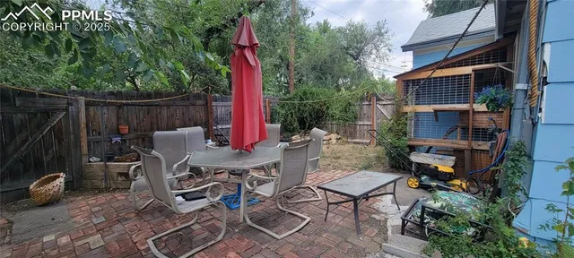 a view of a patio with table and chairs and potted plants