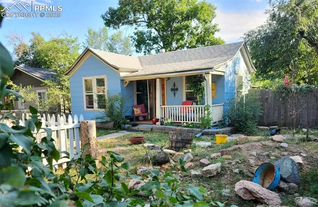 a view of a house with backyard sitting area and swimming pool