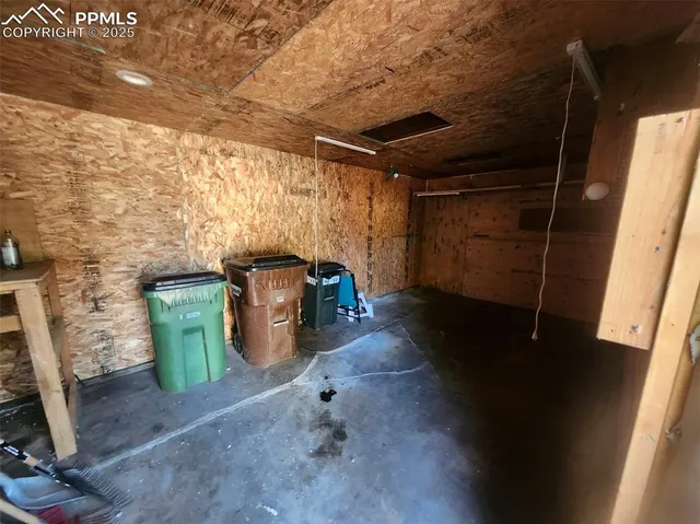 a room with water heater and wooden cabinets