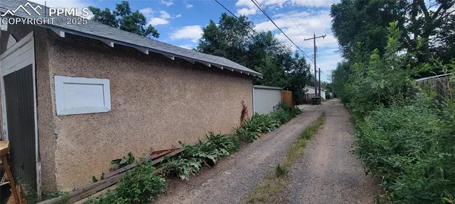 a backyard of a house with plants and trees