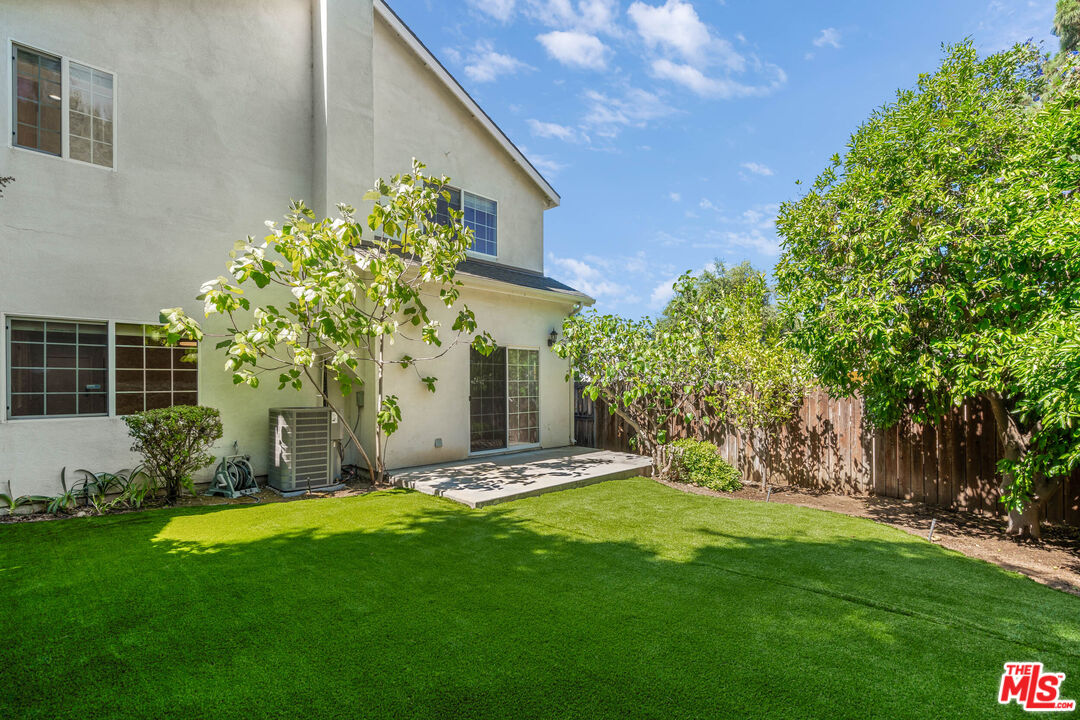 2409 Olive Avenue La Crescenta, CA 91214 - Photo 12 of 25 a view of a backyard with plants and a large tree