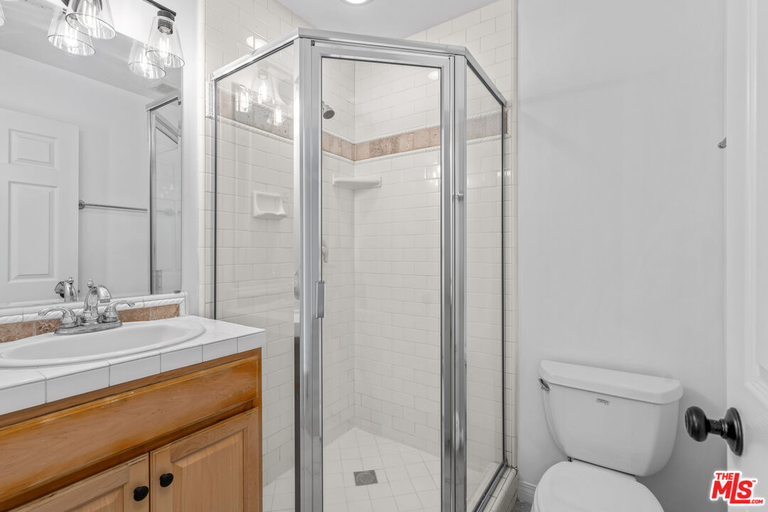 2409 Olive Avenue La Crescenta, CA 91214 - Photo 19 of 25 a bathroom with a granite countertop sink toilet and shower