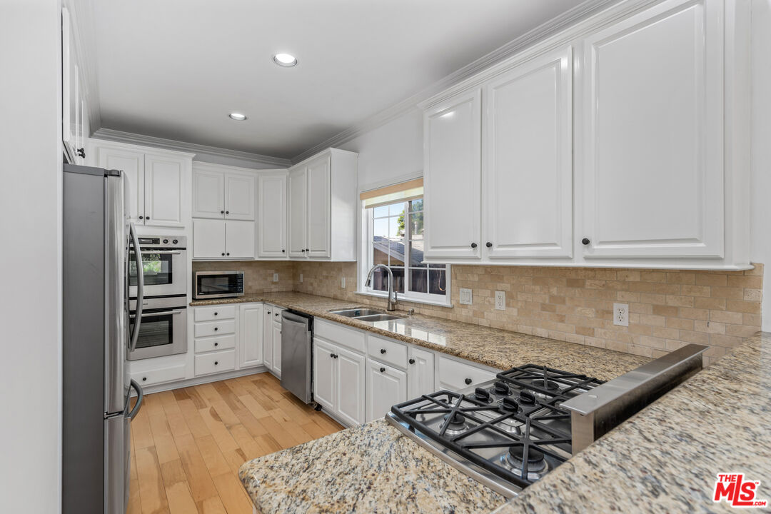 2409 Olive Avenue La Crescenta, CA 91214 - Photo 7 of 25 a kitchen with a stove a sink and a refrigerator