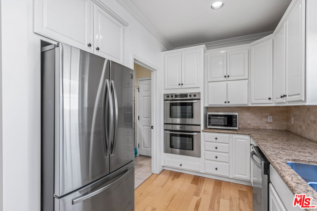 2409 Olive Avenue La Crescenta, CA 91214 - Photo 8 of 25 a kitchen with stainless steel appliances a refrigerator sink and cabinets