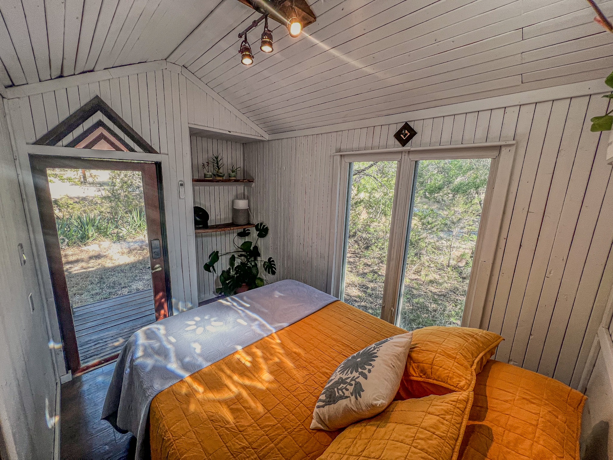 550 Cliffside Road Wimberley, TX 78676 - Photo 32 of 35 a bed sitting in a bedroom next to a window