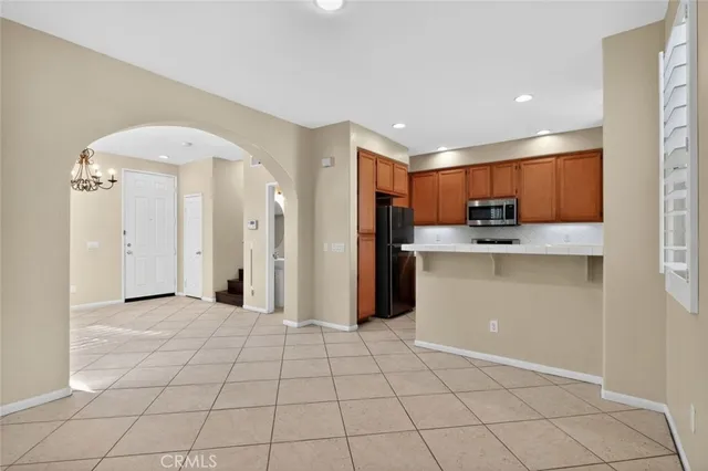 a open kitchen with cabinets and stainless steel appliances