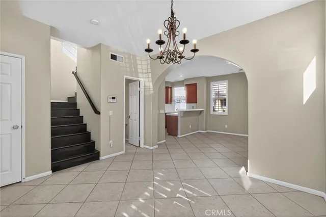 a view of a room with a chandelier and fireplace