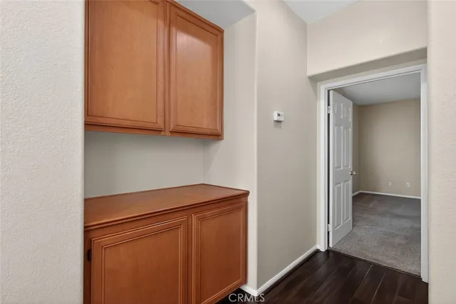 a view of storage and utility room with wooden floor