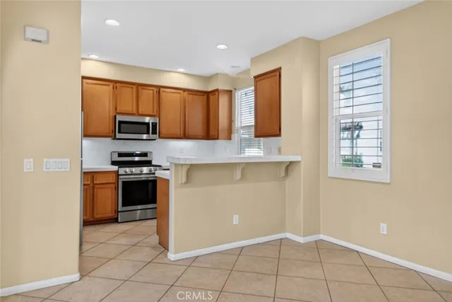 a kitchen with kitchen island granite countertop a stove a sink and a refrigerator
