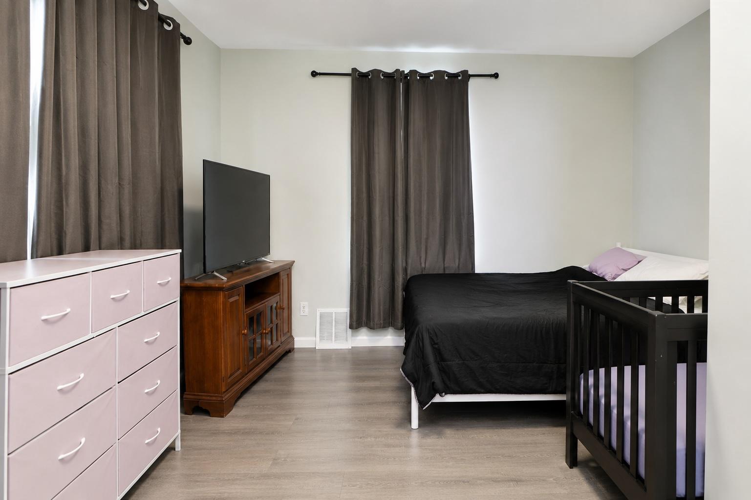 1022 Penn Line Road Paulsboro, NJ 08066 - Photo 6 of 19 a bedroom with a bed and a flat tv screen on dresser
