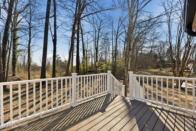 a view of balcony with wooden floor and fence