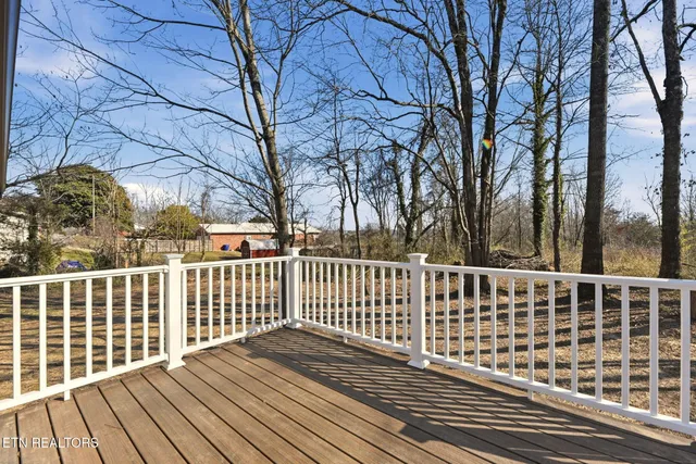a view of balcony with wooden floor and fence