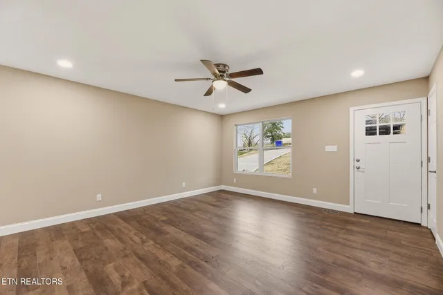 wooden floor in an empty room with a window
