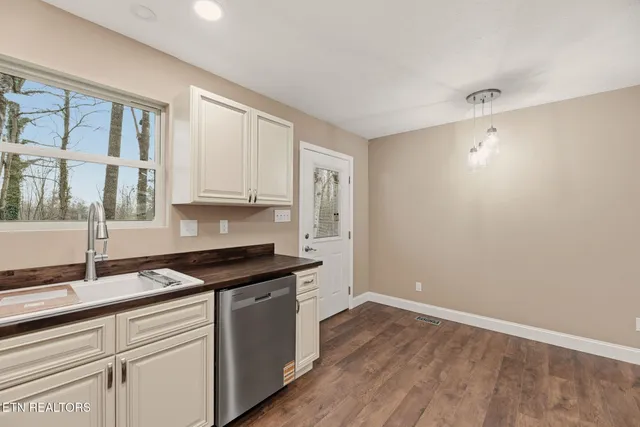 a kitchen that has a sink and cabinets