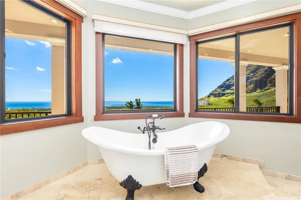 a white bath tub sitting in front of a window