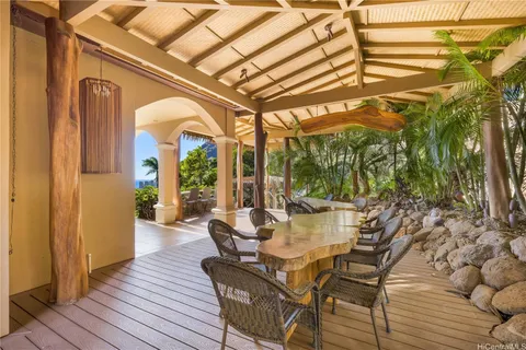 a view of a patio with furniture and wooden floor