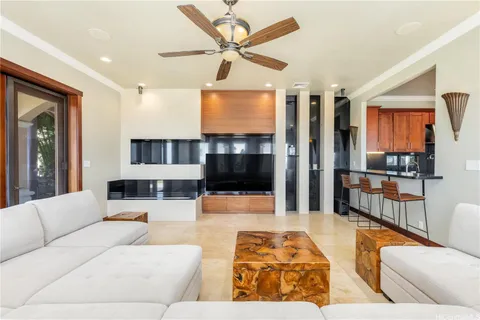 a living room with furniture a rug and a flat screen tv