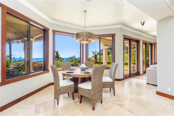 a dining room with wooden floor a chandelier a glass table and chairs