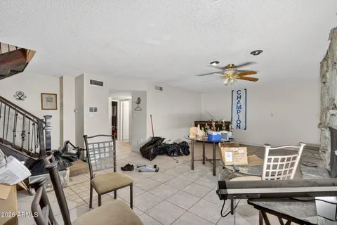 a living room with furniture and a chandelier