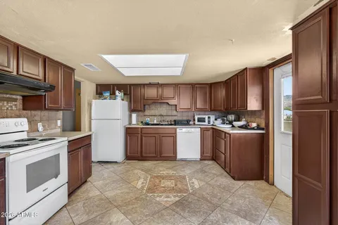 a kitchen with a refrigerator sink and cabinets