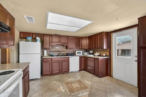a kitchen with stainless steel appliances granite countertop a refrigerator stove and sink