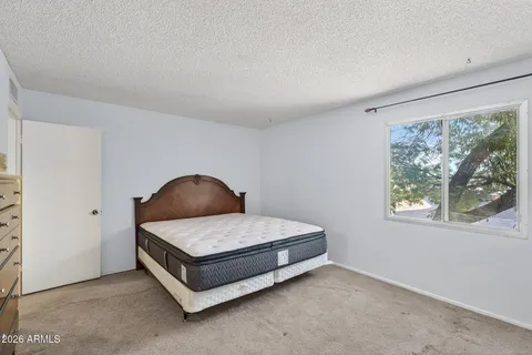 a bedroom with a bed and a dresser