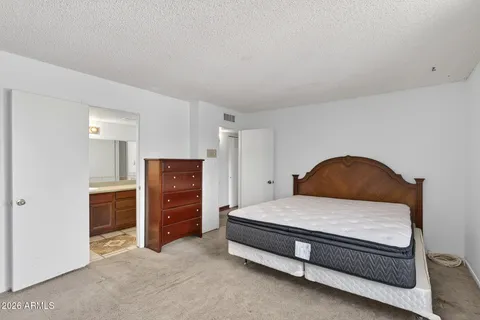 a bedroom with a bed and a cabinets