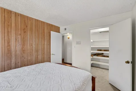 a bedroom with a bed and window
