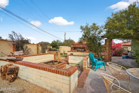 a view of a house with a yard and sitting area