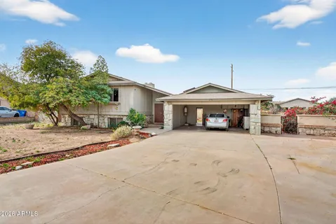 a front view of a house with a yard and a garage