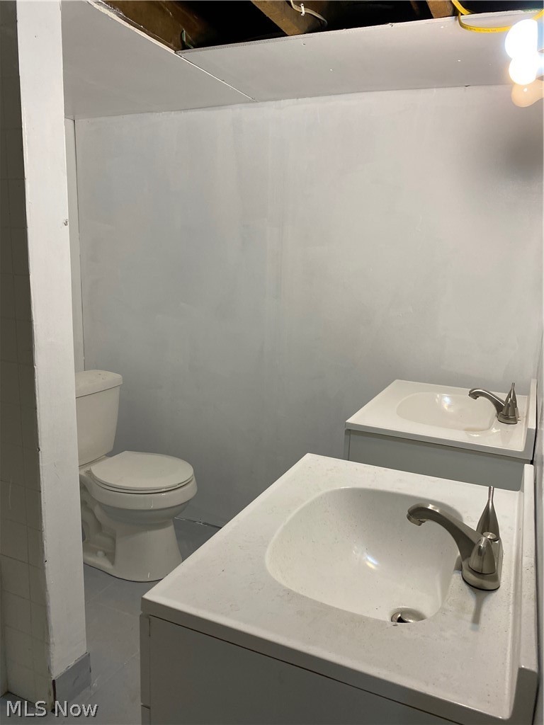 6595 Waterloo Road Atwater, OH 44201 - Photo 21 of 28 Basement bathroom with new vanities and toilet.