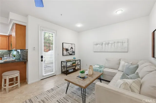 a living room with furniture a rug and a window