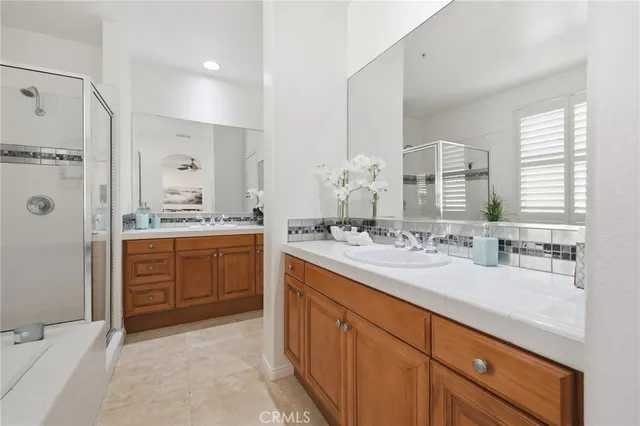 a spacious bathroom with a granite countertop sink mirror and a