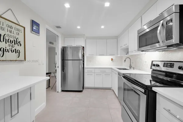 a kitchen with a sink stove and refrigerator