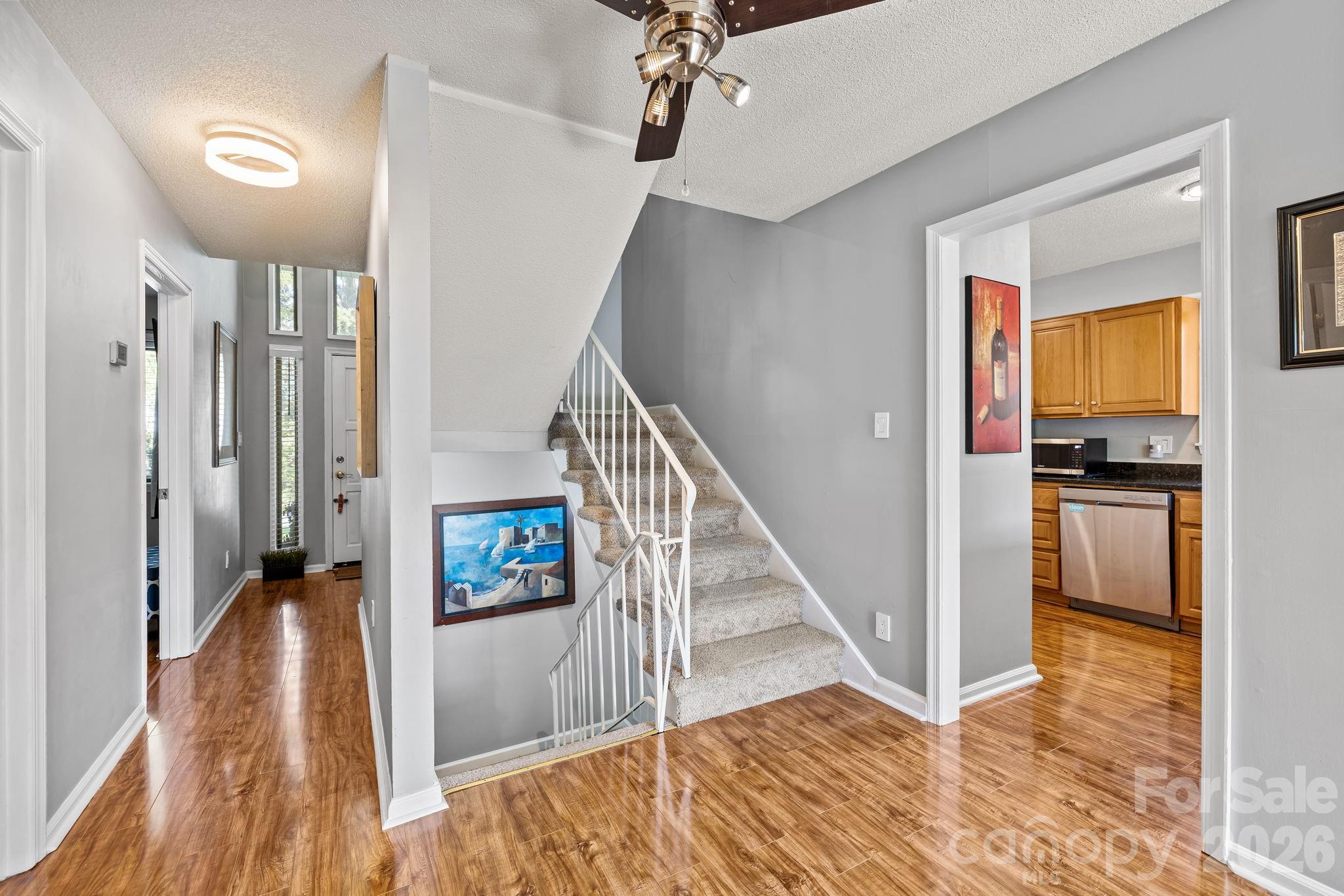 9067 Tulagi Court Fort Mill, SC 29708 - Photo 12 of 44 a view of a hallway view with living room and wooden floor