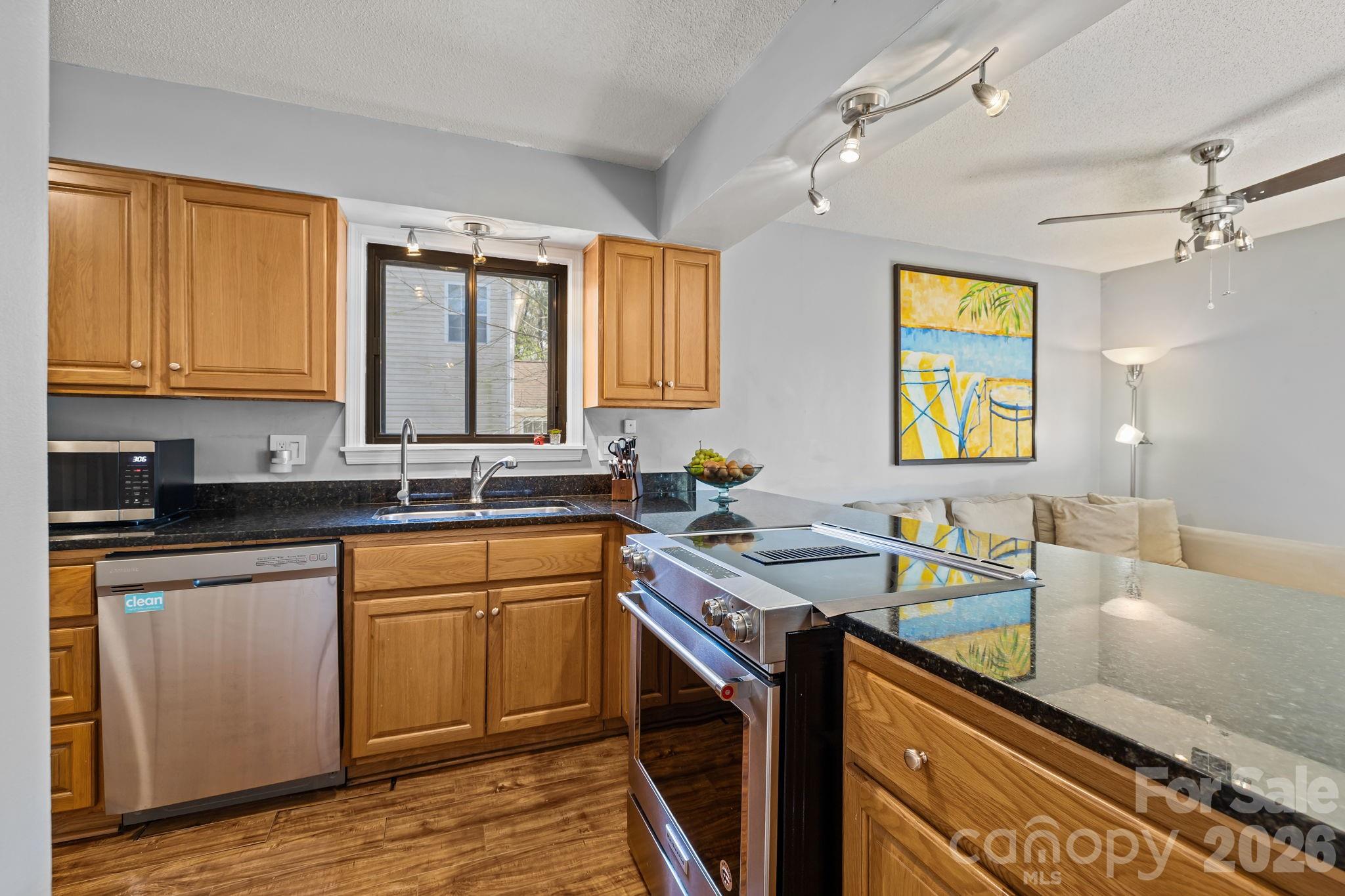 9067 Tulagi Court Fort Mill, SC 29708 - Photo 19 of 44 a kitchen with a sink stove and cabinets