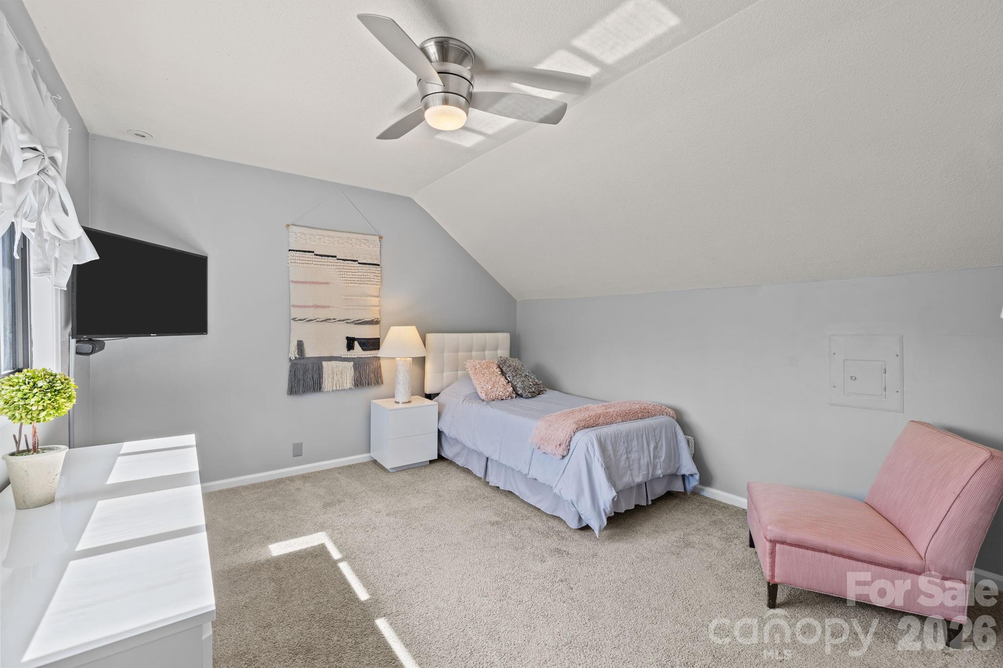 9067 Tulagi Court Fort Mill, SC 29708 - Photo 22 of 44 a spacious bedroom with a bed and a flat screen tv