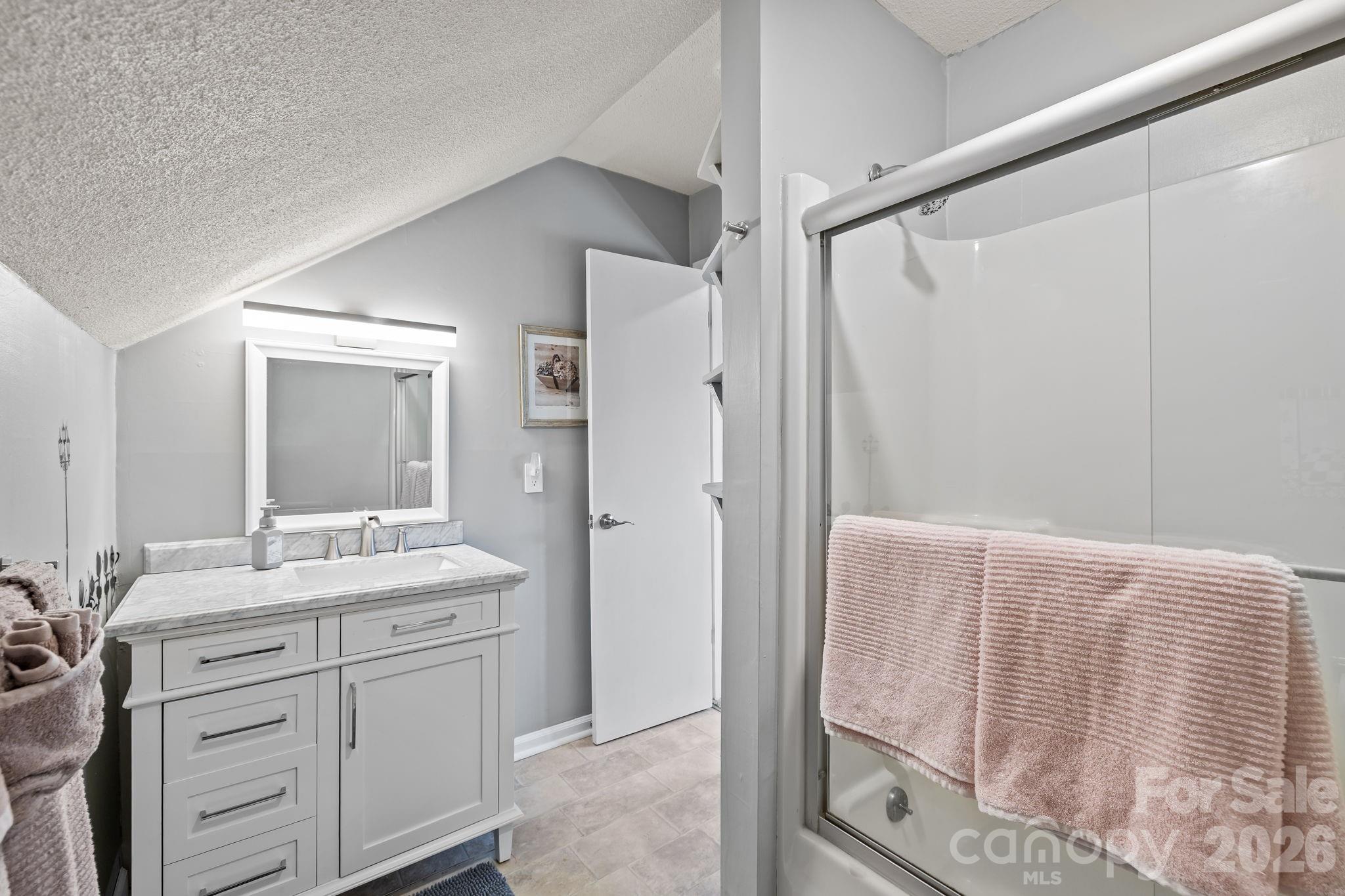9067 Tulagi Court Fort Mill, SC 29708 - Photo 25 of 44 a bathroom with a double vanity sink mirror and shower