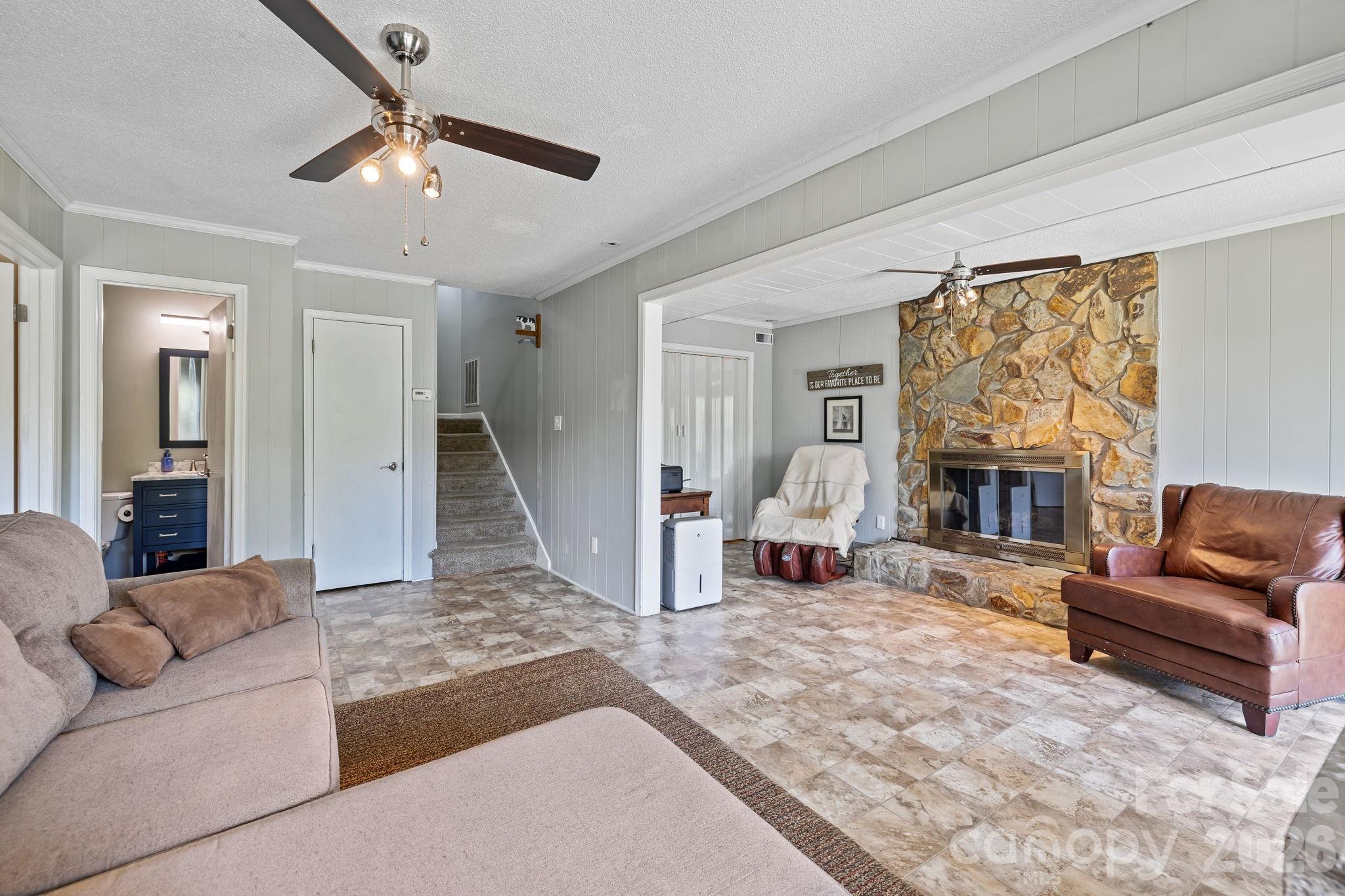 9067 Tulagi Court Fort Mill, SC 29708 - Photo 30 of 44 a living room with furniture and a fireplace